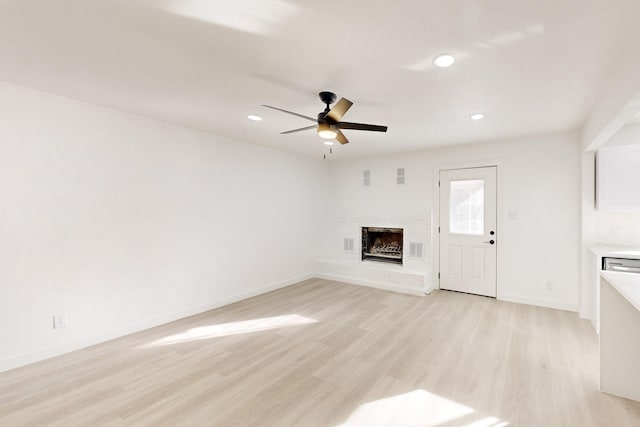 unfurnished living room with ceiling fan and light hardwood / wood-style floors