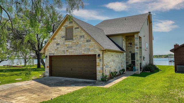 view of front of property with a water view, a garage, and a front yard