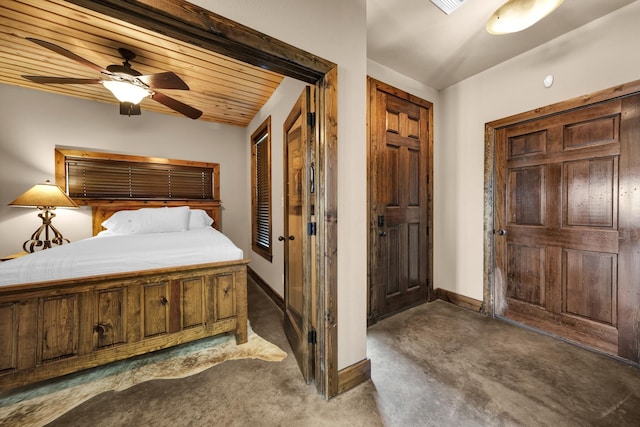 bedroom with ceiling fan, wooden ceiling, and dark carpet