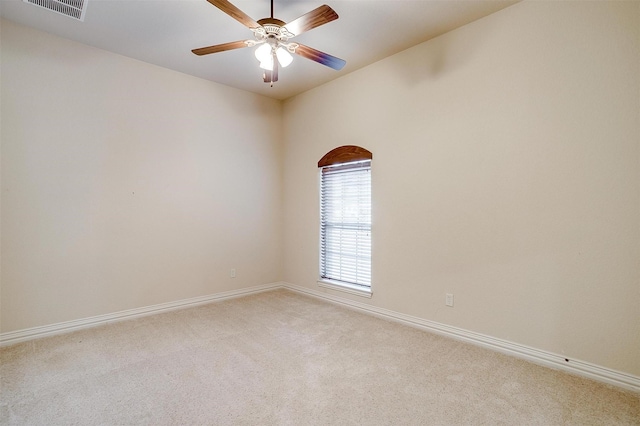 carpeted empty room featuring ceiling fan