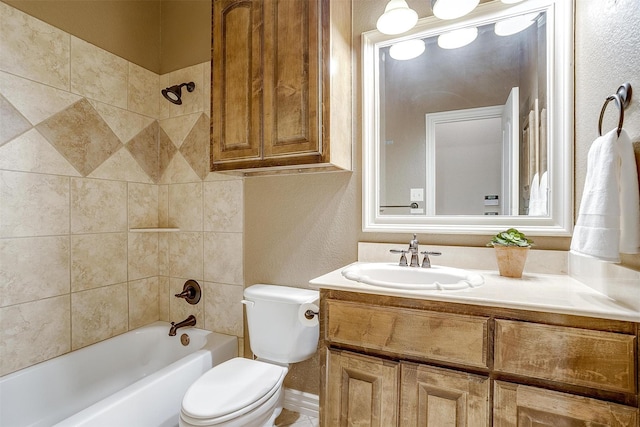 full bathroom with toilet, tiled shower / bath combo, and vanity