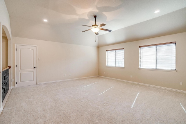 unfurnished room featuring ceiling fan, light carpet, and lofted ceiling