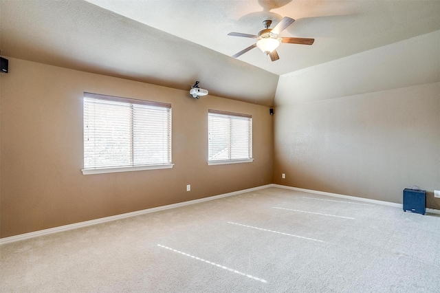 spare room with lofted ceiling, ceiling fan, and carpet floors