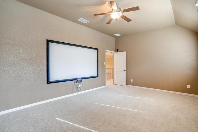 carpeted home theater featuring ceiling fan and vaulted ceiling