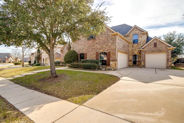 view of front of home featuring a garage and a front lawn