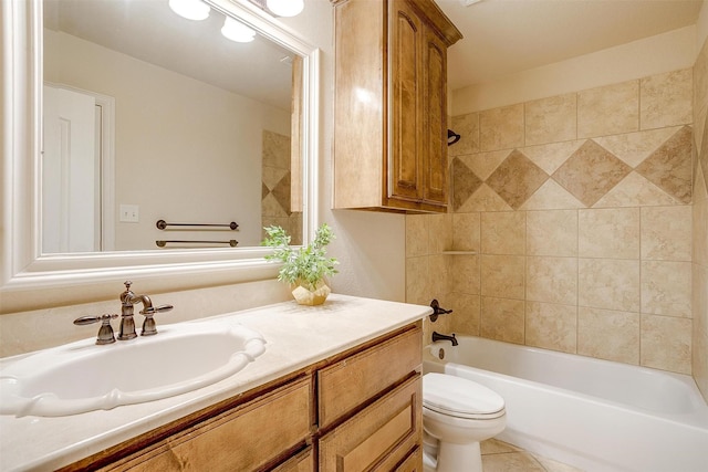 full bathroom featuring toilet, vanity, tile patterned flooring, and tiled shower / bath combo