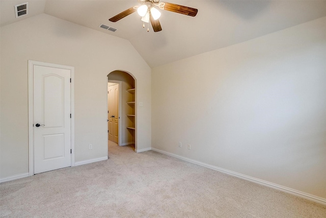 carpeted empty room featuring ceiling fan and lofted ceiling