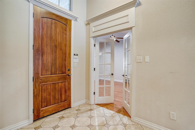 entrance foyer with ceiling fan and french doors