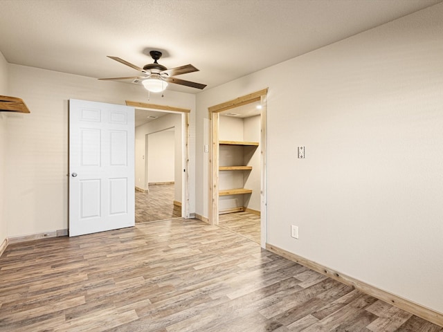 unfurnished room featuring ceiling fan and hardwood / wood-style floors