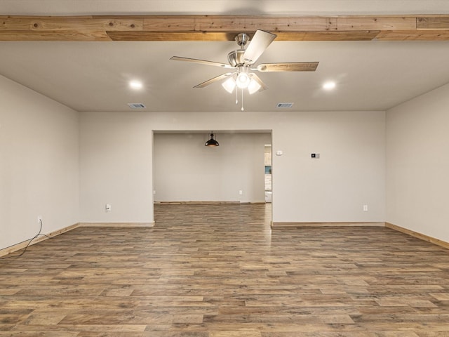 spare room featuring ceiling fan, hardwood / wood-style floors, and beam ceiling