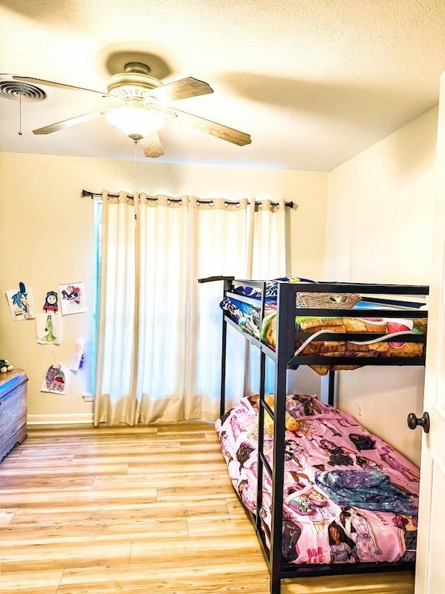 bedroom featuring ceiling fan and hardwood / wood-style flooring