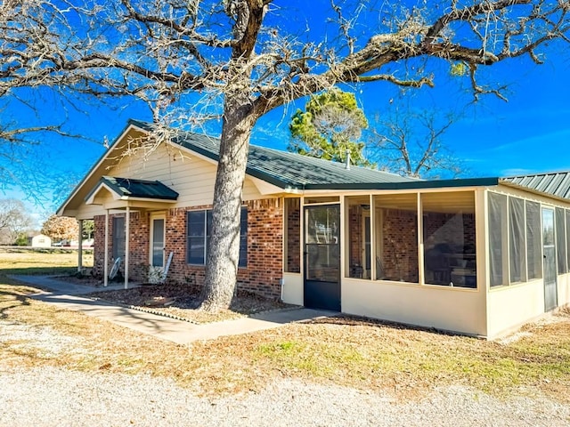 view of front of property featuring a sunroom