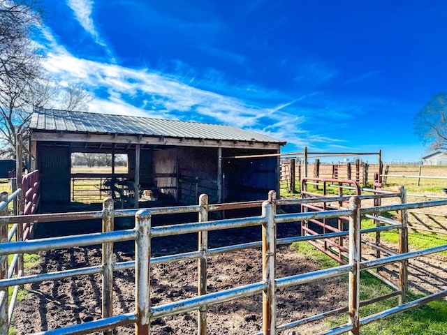 view of horse barn featuring a rural view