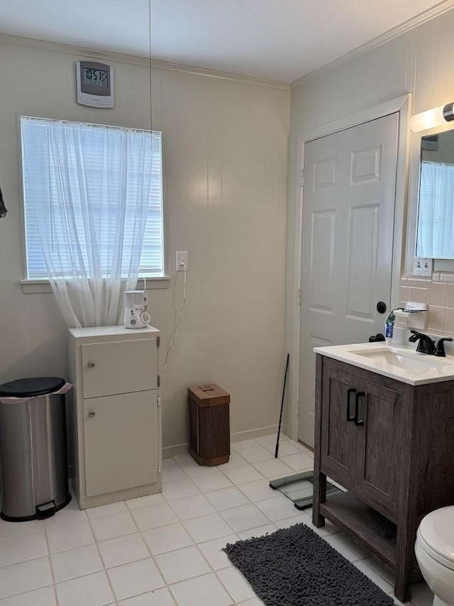 bathroom featuring tile patterned floors, toilet, vanity, and ornamental molding