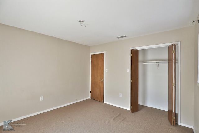 unfurnished bedroom featuring carpet floors and a closet