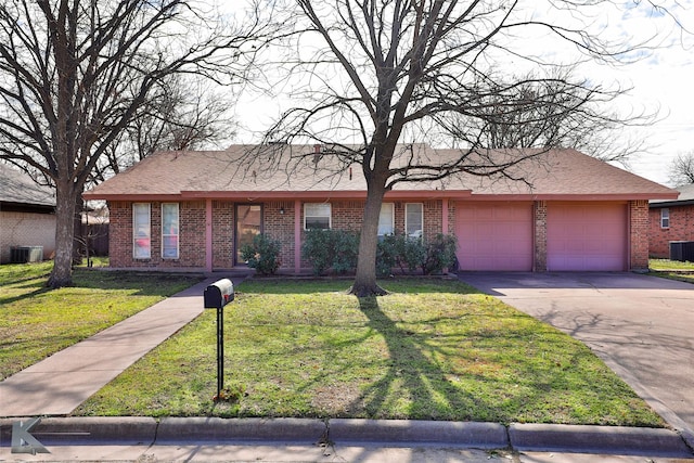 ranch-style home featuring a front lawn, a garage, and central AC