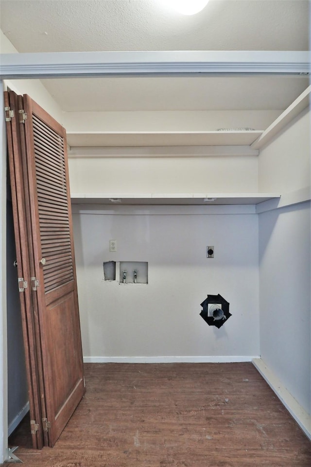 clothes washing area with dark wood-type flooring, hookup for an electric dryer, and hookup for a washing machine