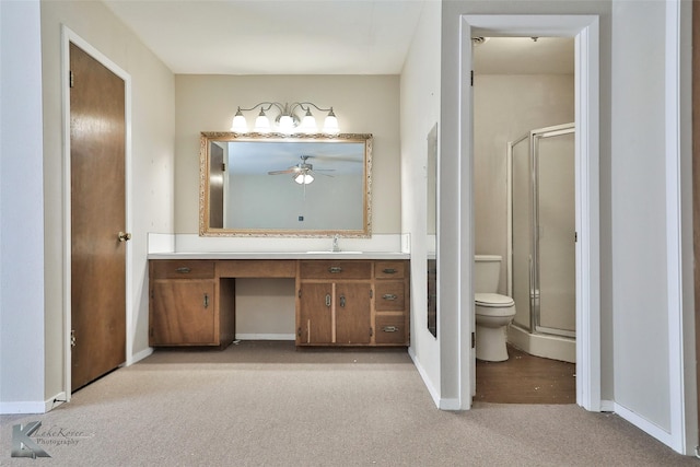 bathroom featuring walk in shower, vanity, ceiling fan, and toilet