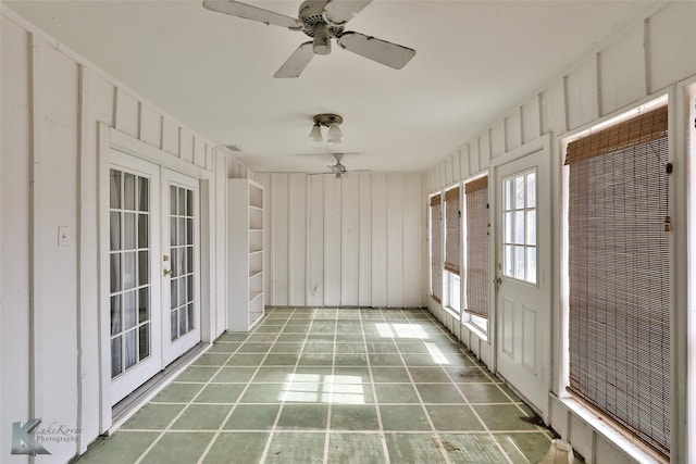 unfurnished sunroom with ceiling fan and french doors