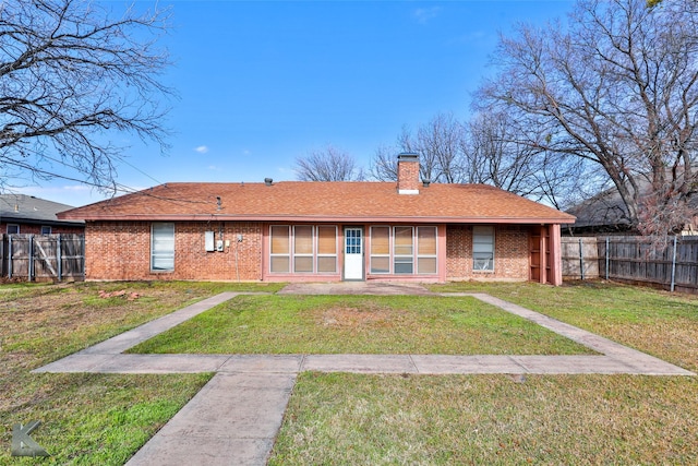 rear view of house with a yard