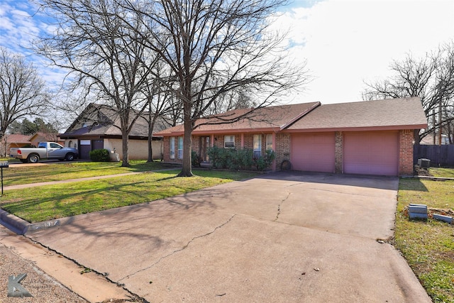 ranch-style house featuring a garage and a front yard