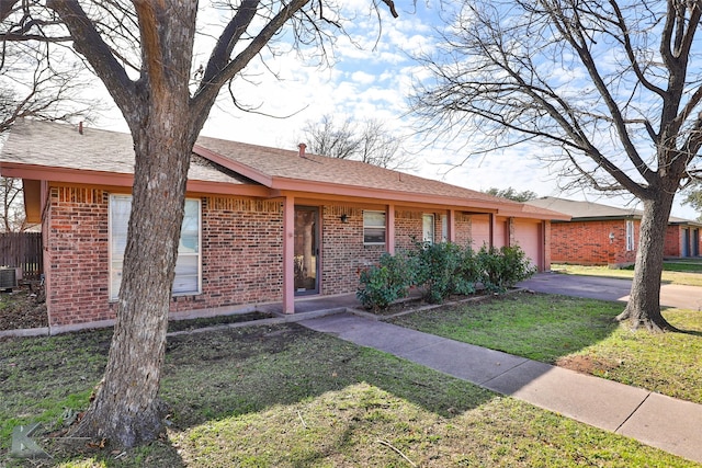 ranch-style home featuring a front yard and central AC