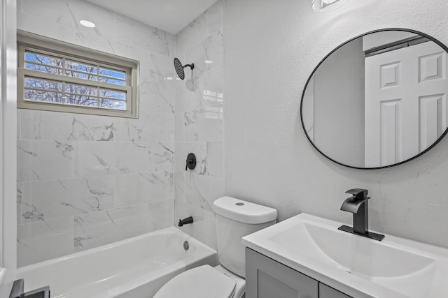 full bathroom featuring vanity, toilet, and tiled shower / bath combo