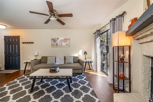 living room with ceiling fan and dark hardwood / wood-style flooring