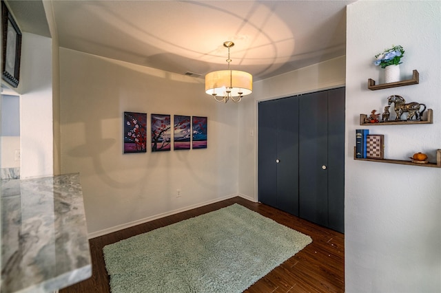 interior space with dark hardwood / wood-style flooring and a notable chandelier