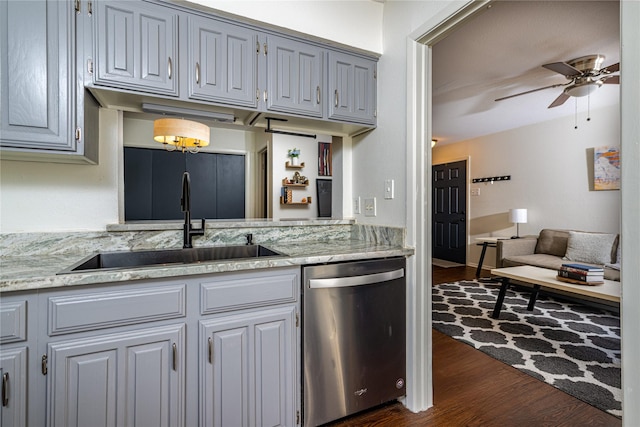 kitchen with ceiling fan, gray cabinetry, dark wood-type flooring, stainless steel dishwasher, and sink