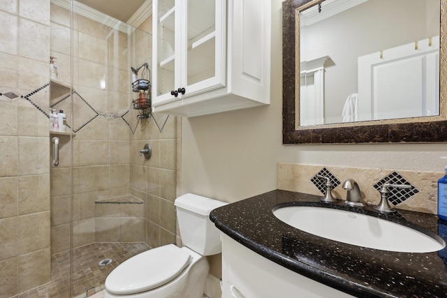 bathroom featuring toilet, vanity, walk in shower, and ornamental molding