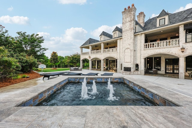 view of swimming pool featuring a patio area and french doors