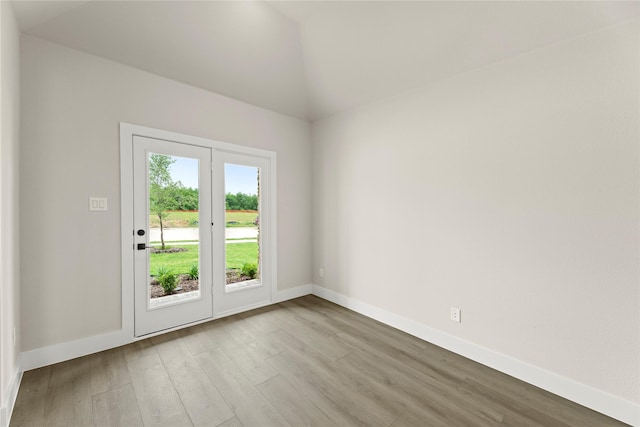 13728 Riola Dr, Little Elm, TX 75068 - doorway with wood finished floors, baseboards, and lofted ceiling
