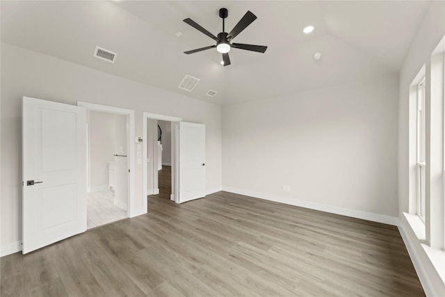 13728 Riola Dr, Little Elm, TX 75068 - unfurnished bedroom featuring lofted ceiling, wood finished floors, baseboards, recessed lighting, and ensuite bath