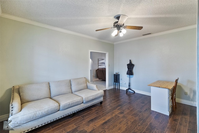 living room featuring dark wood-type flooring, a textured ceiling, and ornamental molding