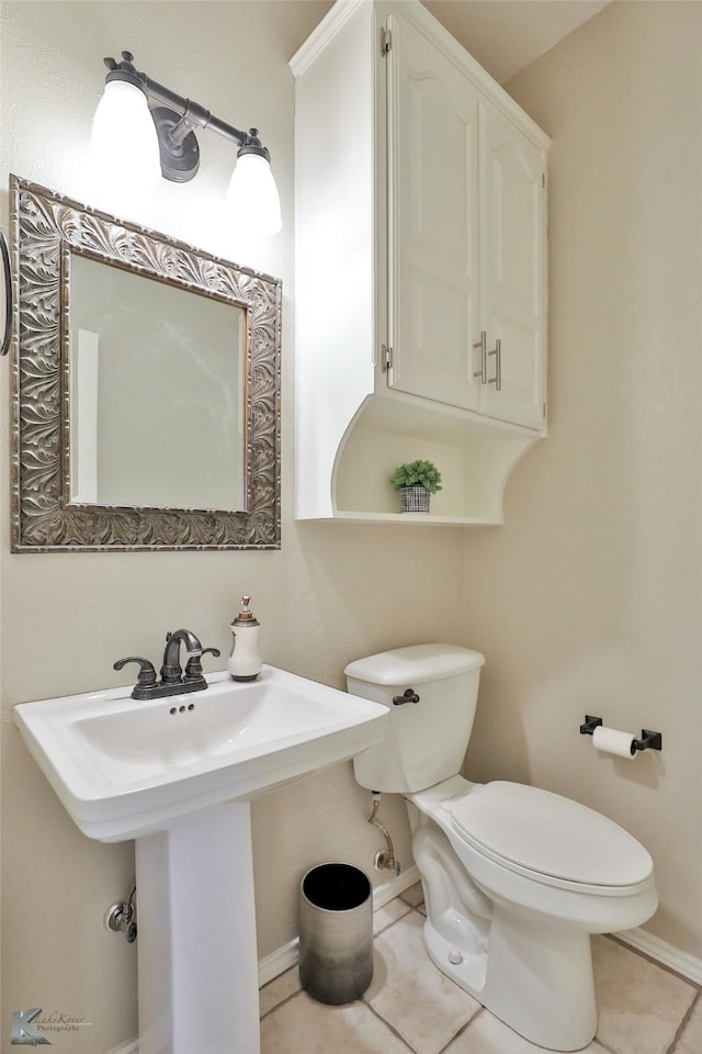 bathroom featuring toilet and tile patterned floors