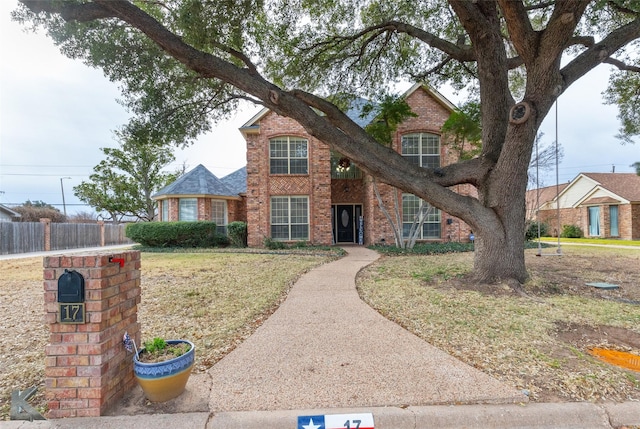 view of property featuring a front lawn