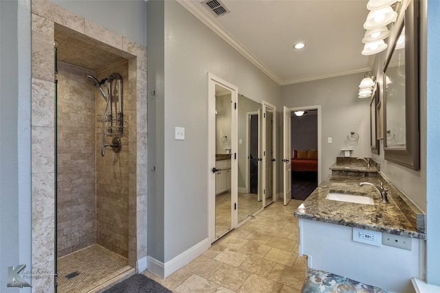 bathroom featuring tiled shower, vanity, and ornamental molding