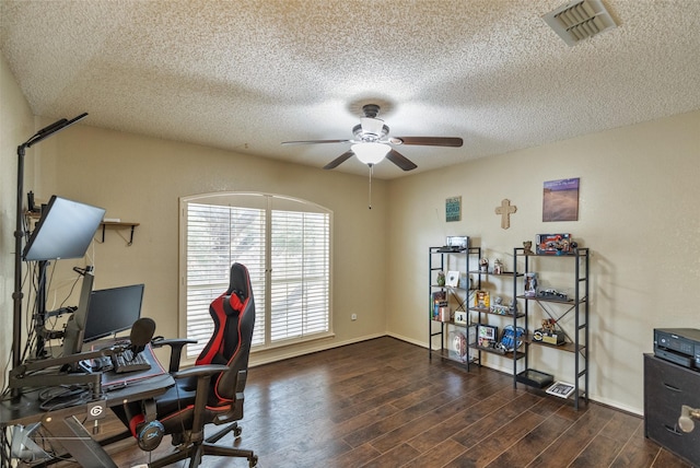 home office with ceiling fan, dark hardwood / wood-style floors, and a textured ceiling