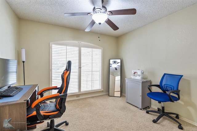 carpeted office space with ceiling fan and a textured ceiling