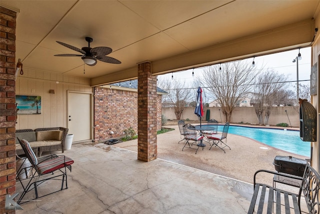 view of patio featuring ceiling fan and a fenced in pool