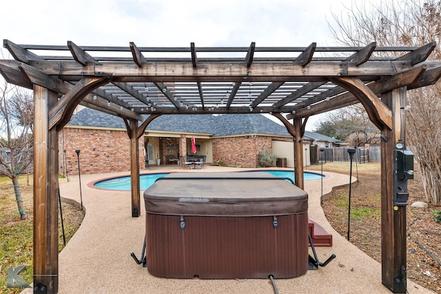 exterior space featuring a hot tub and a pergola