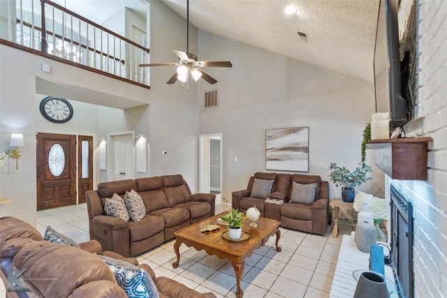 living room with high vaulted ceiling, a textured ceiling, light tile patterned floors, and ceiling fan