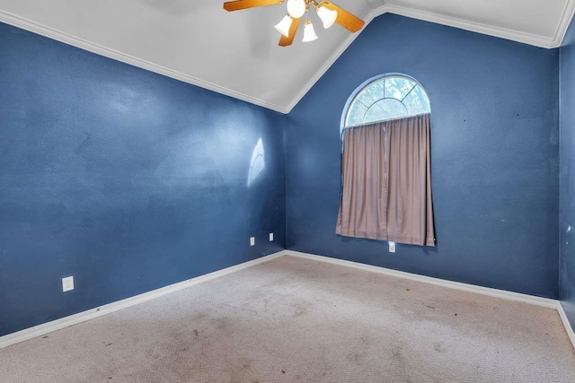 carpeted empty room featuring crown molding, lofted ceiling, and ceiling fan