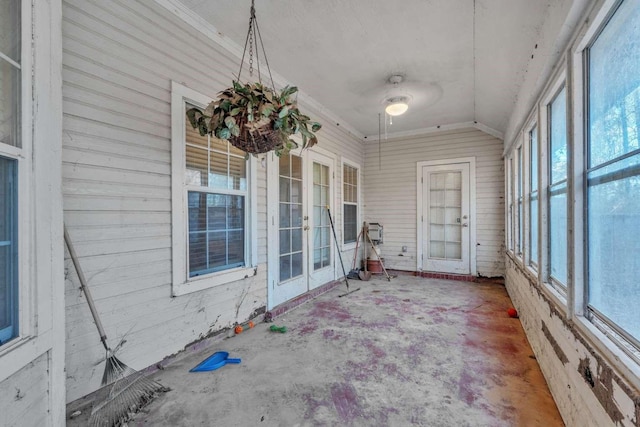 unfurnished sunroom featuring french doors, plenty of natural light, and vaulted ceiling