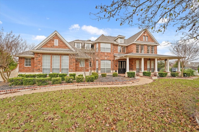 view of front of house with covered porch and a front yard