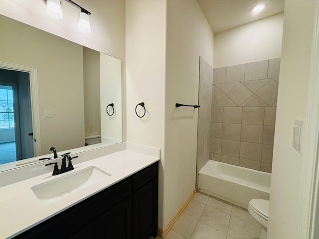 full bathroom featuring tiled shower / bath combo, vanity, tile patterned floors, and toilet