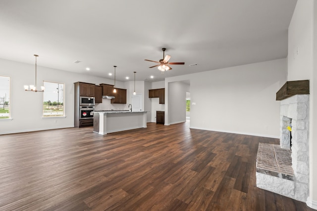 120 Roosevelt Ln, Valley View, TX 76272 - unfurnished living room featuring ceiling fan with notable chandelier, a sink, a wealth of natural light, and dark wood-type flooring
