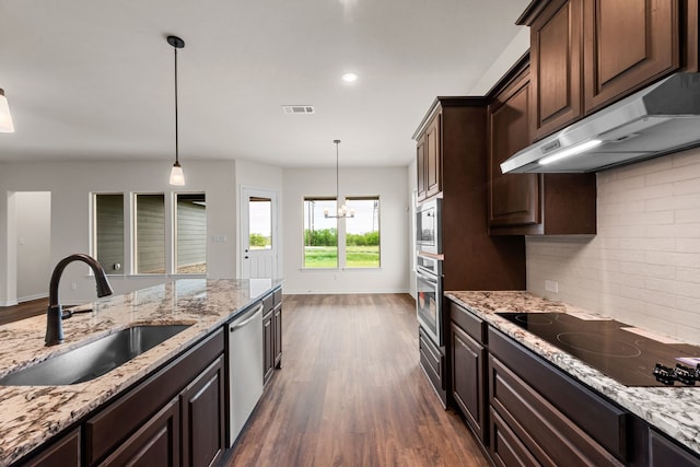 120 Roosevelt Ln, Valley View, TX 76272 - kitchen with dark wood finished floors, under cabinet range hood, visible vents, a sink, and appliances with stainless steel finishes