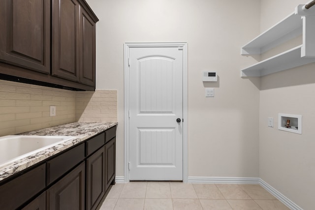 120 Roosevelt Ln, Valley View, TX 76272 - laundry area featuring cabinet space, washer hookup, baseboards, and light tile patterned floors